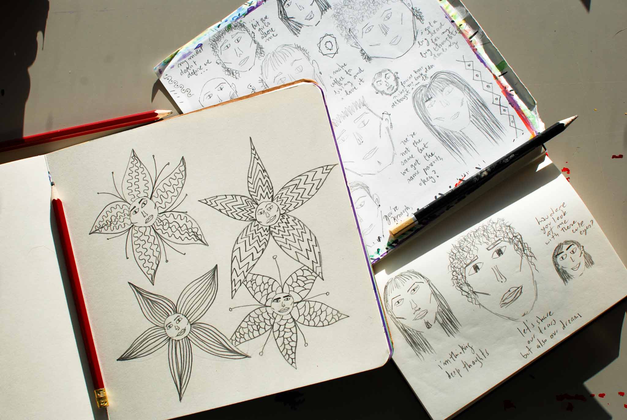 Open sketchbooks with hand-drawn illustrations